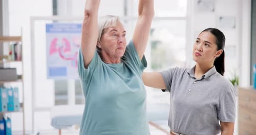 Senior Woman Doing Physical Therapy with Assistant