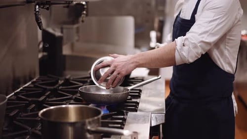 Chef Cooking Ingredients in a Restaurant Kitchen