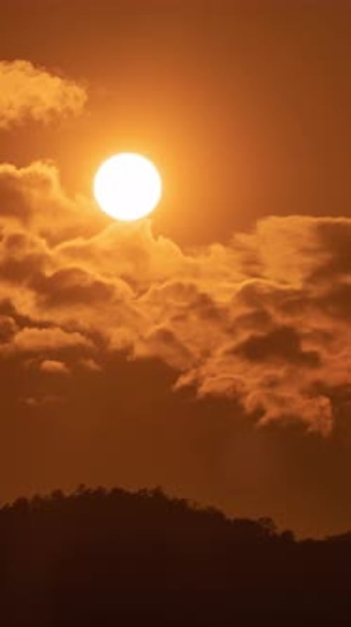 Timelapse of dramatic sunset with orange sky in a sunny day.
