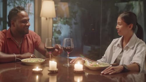 Couple Enjoying Romantic Candlelit Dinner Together at Home