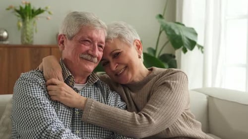 Senior Couple Embracing Affectionately at Home