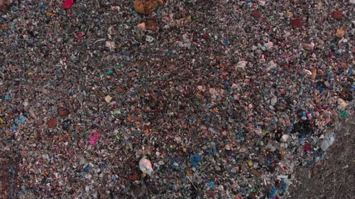 Aerial Top down view through pile of garbage landfill site, Environmental pollution