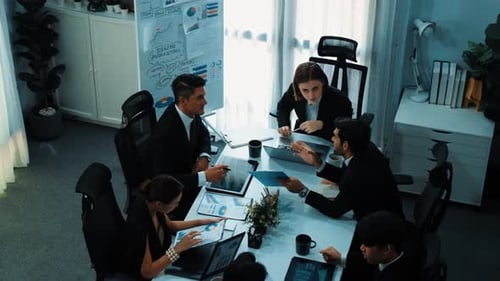 Top view of female leader looking financial statistic at meeting. Directorate.