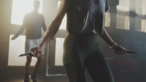 Woman and Man Jump Roping in a Fitness Center