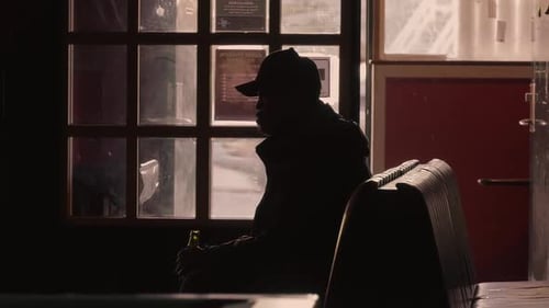 Man Sits Alone, Silhouette in Dim Light