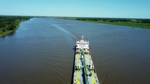 Overtake Shot Of Large Red Commercial Ship Cruising Beautiful Blue River, Paraguay