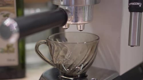 Espresso Pouring Into Glass Cup From Machine