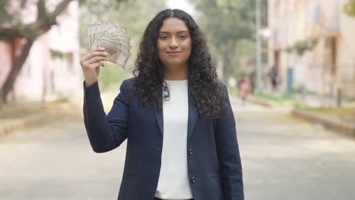 Curly Hair Indian Businesswoman Using Money Fan