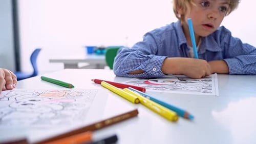 Children Drawing Paint with Colorful Pencils Coloring Book in Educational Class at School