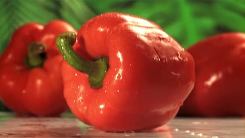 Red Bell Pepper Falls on a Wet Table Filmed on a Highspeed Camera at 1000 Fps