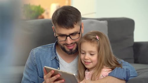Dad and Daughter Enjoying Tablet Time Together