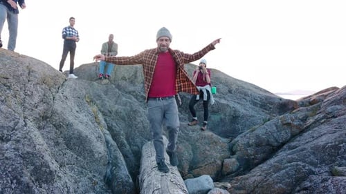 Group of Friends Hiking Along Rocky Coastline