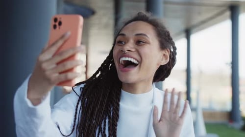 Attractive Woman Using Mobile Phone for Video Call Online Feel Happy Video Chat Stand Outdoors on