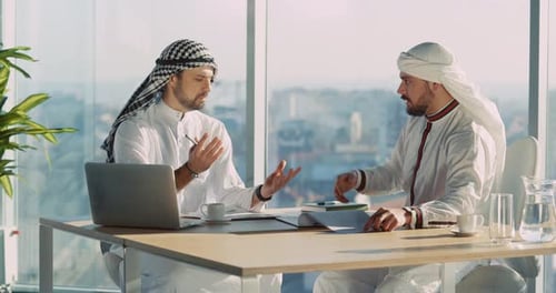 Two Arabian Young Businessmen Talking Together Planning Construction of New Company Office Building