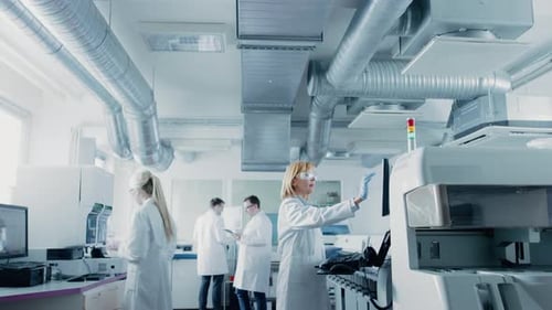 Scientists working with equipment in the modern laboratory