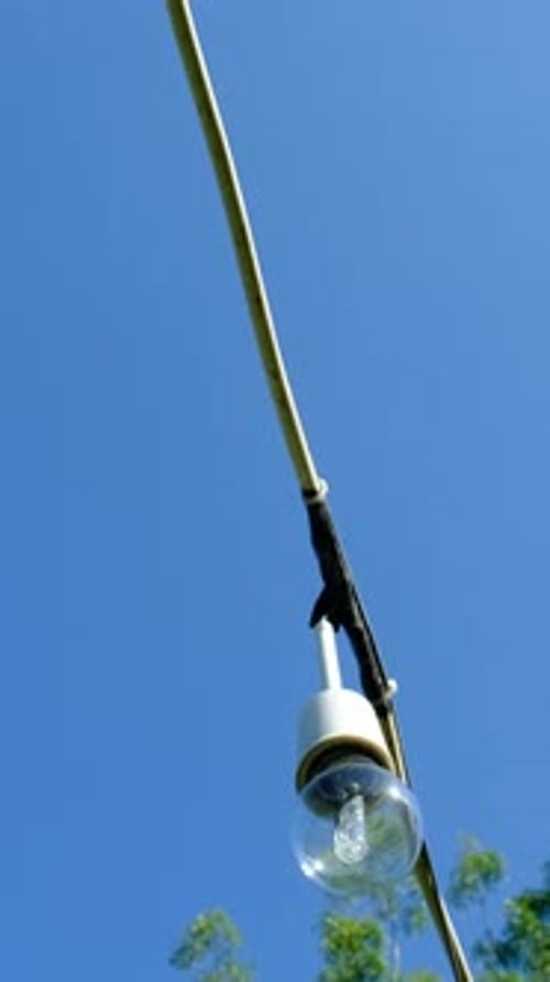 Outdoor String Lights Against a Clear Blue Sky