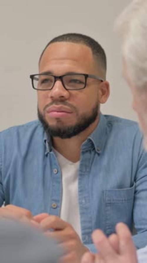 Close up of Hispanic Man Talking with Teammates, vertical video