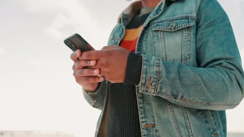 Beach, cellphone and closeup of man typing a text message or email on the internet or website