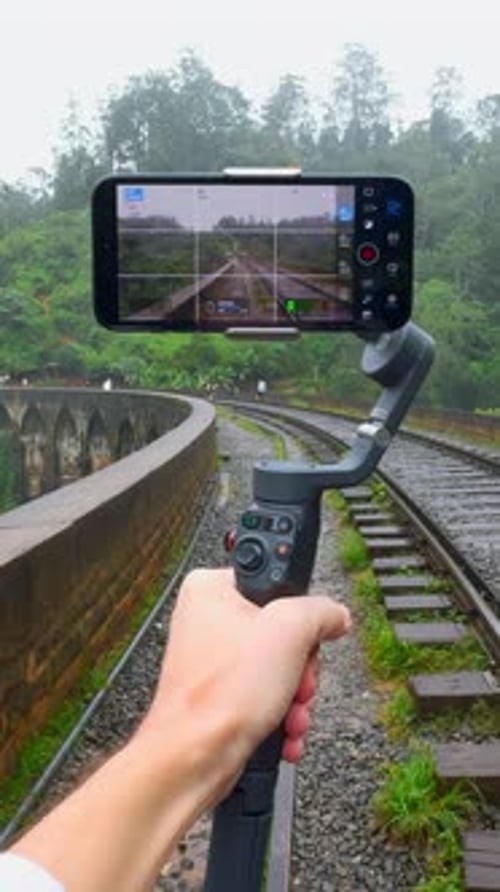 Shooting of Trip on Tripod Phone Action Blogger Professionally Shoots Videos on Phone While