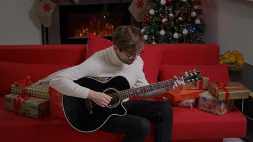 Man Plays Guitar At Christmas Time