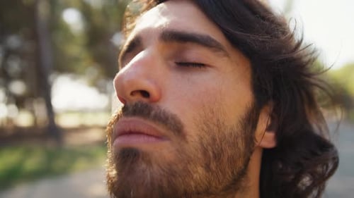 Italian Man with Long Hair Breathes Concentrated Pure Air in the Mountains