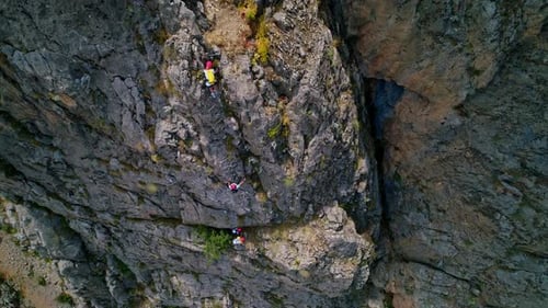 Rock Climbers Ascend Sheer Cliff Face