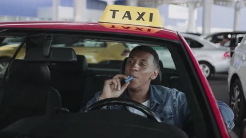 Taxi Driver Waiting in His Cab