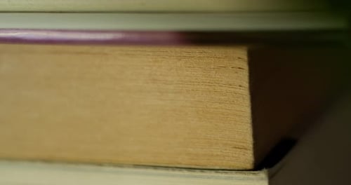 closeup of old yellowing book pages on bookshelf in a cozy home
