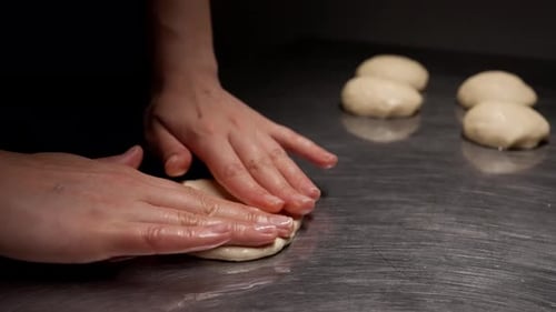 Hands Shaping Dough on Metal Counter for Cooking