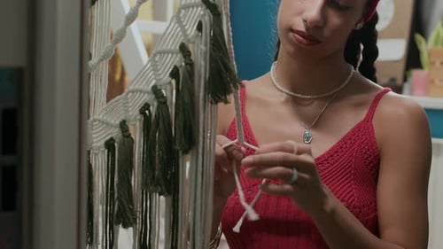 Young Adult Creating Macrame String Wall Hanging