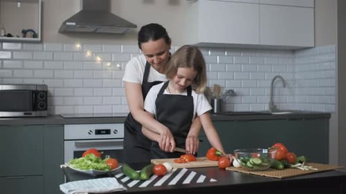 Mother and Child Smiling, Cooking Together in Kitchen