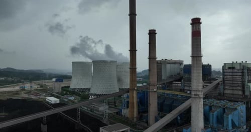 Aerial Drone Footage of a Large Coal Power Plant Station with Cooling Towers Chimney and Boiler