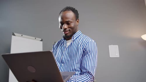Busy, typing and a black man with a laptop at work for communication, email or networking