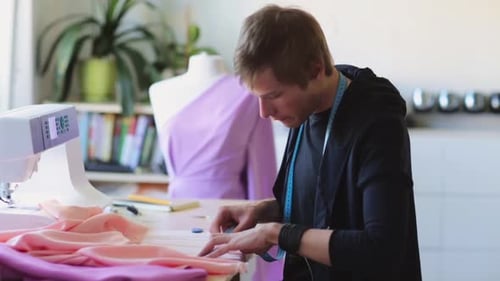 Fashion designer creates bespoke clothing in his tailoring studio workshop