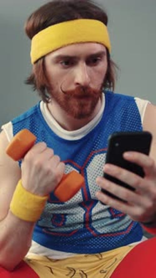 A Vintage Fitness Enthusiast is Checking Their Smartphone While Staying Active and Stylish