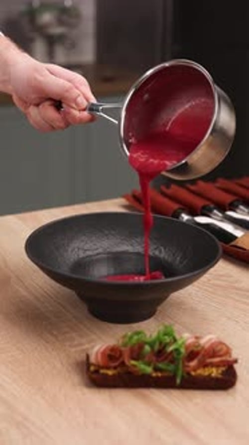 The chef is preparing a puree soup in the kitchen. Close-up