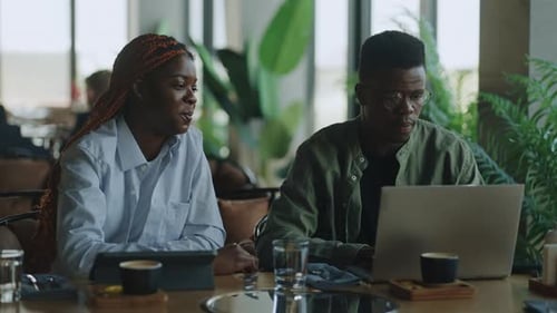 Young Black Entrepreneurs Brainstorming a New StartUp Idea in Hipster Coffee Shop