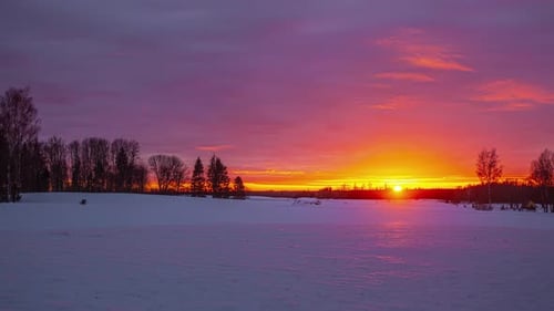 Picturesque Sunset Over a Snow Covered Field