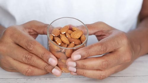 Hands Holding Glass of Almonds, Healthy Snack