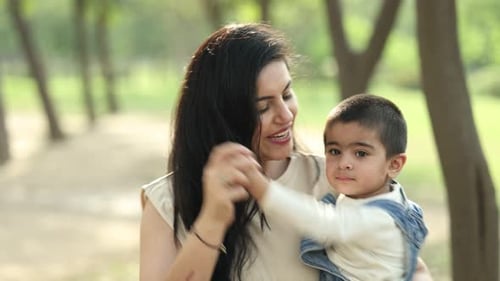 Mother And Child Enjoy A Sunny Day At The Park