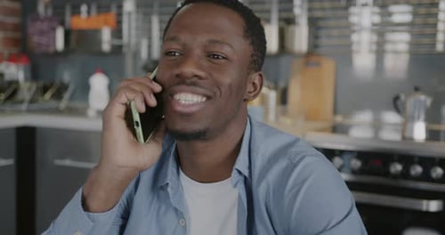 Man Talking on Phone in Modern Kitchen