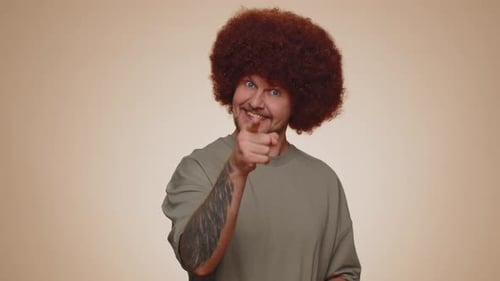 Happy Man with Red Curly Hair Gesturing