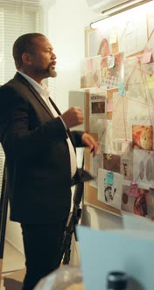 Detective, anxious and man with board, police station and frustrated with lack of evidence or clues