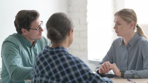 Close Up of Young People Discussing Work During Meeting