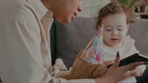 Child Celebrates Birthday With Parent And Party Hats