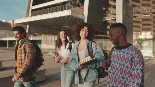 Classmates students walk down the street talking and laughing together