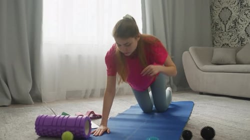Woman Exercising at Home on Yoga Mat