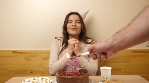Happy Young Woman Celebrates Birthday with Cake Indoors
