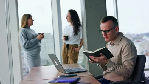 Man Working on Laptop in Modern Office