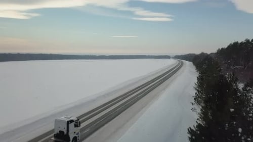 Top View of the Winter Road on Which Cars and Trucks Drive